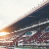 Stadium background with a green grass pitch in the daytime Stadium background with a green grass pitch in the daytime